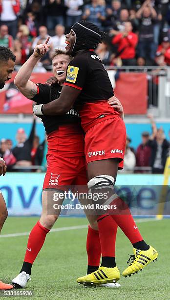 Chris Ashton of Saracens celebrates with team mate Maro Itoje after scoring a try during the Aviva Premiership semi final match between Saracens and...