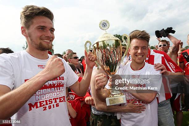 Jonas Nietfeld and team mate Patrick Goebel of Zwickau pose with the trophy after winning the Regionalliga Nordost championship title after the...