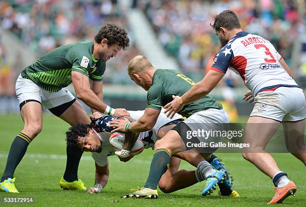 Folau Niua of the USA is caught by Ryan Kankowski and Kyle Brown of South Africa during the match between South Africa and the United States of...