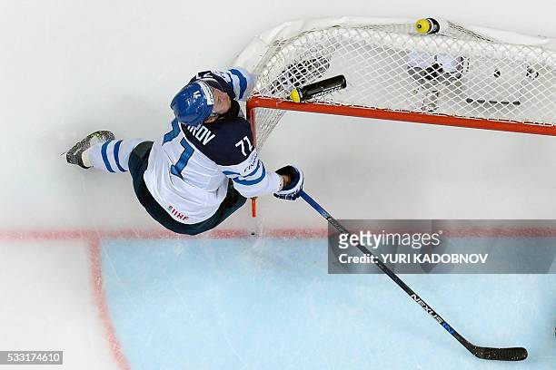 Finland's forward Leo Komarov slides in the net of Russia's goalie Sergei Bobrovski during the semifinal game Finland vs Russia at the 2016 IIHF Ice...