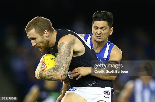 Zach Tuohy of the Blues is tackled by Robin Nahas of the Kangaroos during the round nine AFL match between the North Melbourne Kangaroos and the...