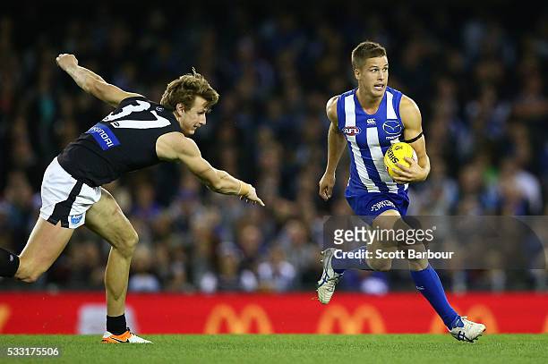 Andrew Swallow of the Kangaroos runs with the ball during the round nine AFL match between the North Melbourne Kangaroos and the Carlton Blues at...