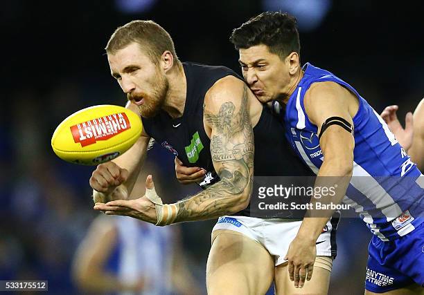 Zach Tuohy of the Blues is tackled by Robin Nahas of the Kangaroos during the round nine AFL match between the North Melbourne Kangaroos and the...