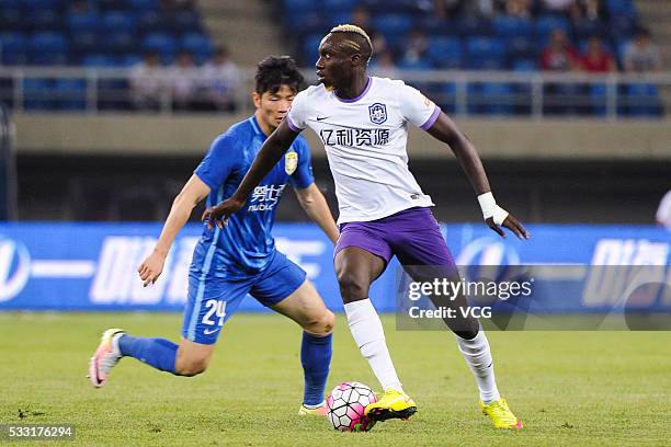 Ji Xiang and Mbaye Diagne of Tianjin Teda compete for the ball during Chinese Football Association Super League Round 10 between Tianjin Teda and...