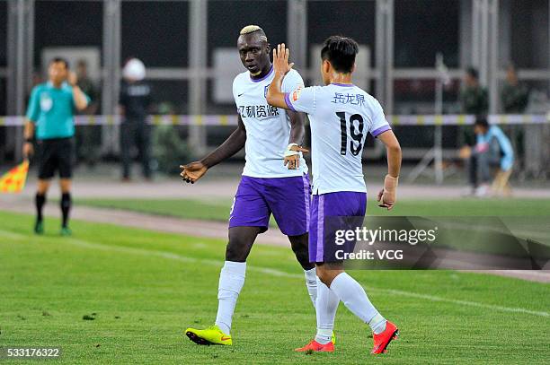 Mbaye Diagne of Tianjin Teda celebrates a goal with teammate Bai Yuefeng of Tianjin Teda during Chinese Football Association Super League Round 10...