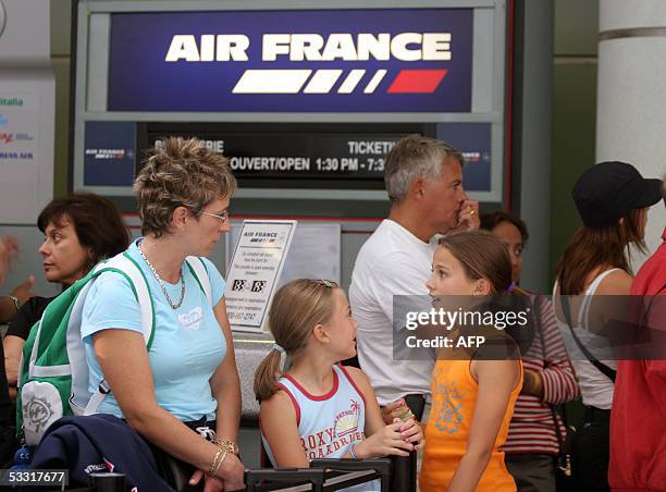 Passengers unable to take Air France flight 358 after it crashed at Pearson International Airport in Toronto, Canada, wait in line in front of the...
