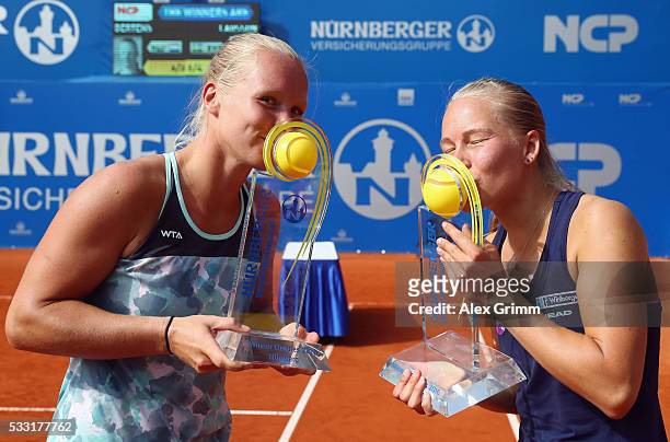 Kiki Bertens of Netherlands and Johanna Larsson of Sweden pose with the trophies after winning their doubles final match against Shuko Aoyama of...