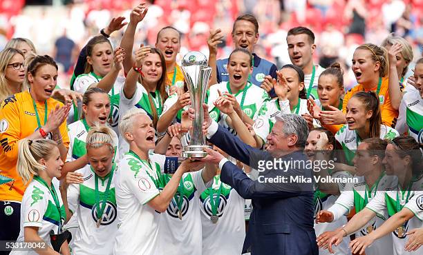 Nilla Fischer of Wolfsburg gets the cup from Joachim Gauck after the women's cup final between SC Sand and VFL Wolfsburg at RheinEnergieStadion on...