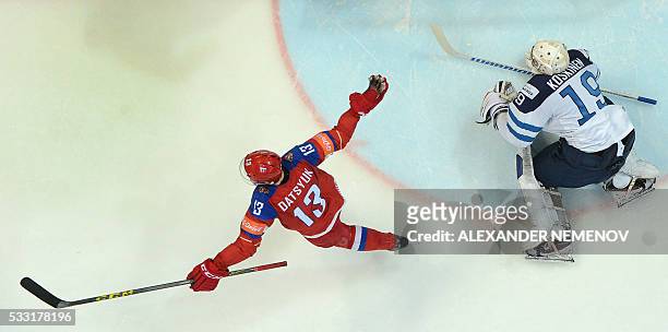 Finland's goalie Mikko Koskinen saves his net as Russia's forward Pavel Datsyuk reacts during the semifinal game Finland vs Russia at the 2016 IIHF...