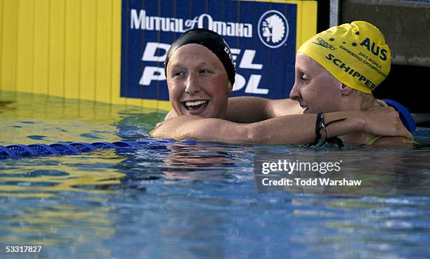 Second place finisher Mary DeScenze of the United States hugs winner Jessicah Schipper of Australia after their race in the 200 meter Butterfly...