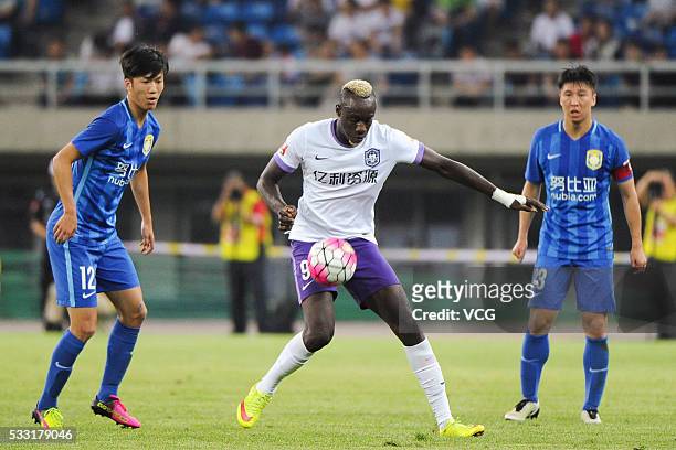 Mbaye Diagne of Tianjin Teda and Zhang Xiaobin of Jiangsu Suning compete for the ball during Chinese Football Association Super League Round 10...