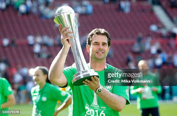Head coach Ralf Kellermann of Wolfsburg celebrates the winning of the trophy after the women's cup final between SC Sand and VFL Wolfsburg at...