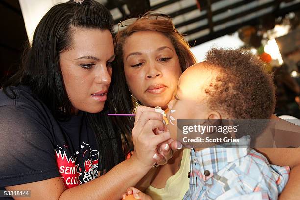 Guests get their faces painted during a fashion show and party to benefit the Make A Wish Foundation at The Park August 2, 2005 in New York City.