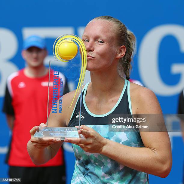 Kiki Bertens of Netherlands poses with the trophy after winning her singles final match against Mariana Duque-Marino of Colombia on day eight of the...