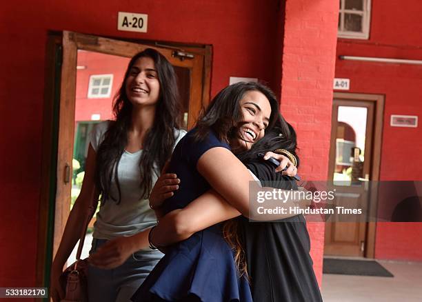 Girl students of St. Thomas School, in joyful mood as they hug each other after passing class XII CBSE Board Exams, results announced today by the...