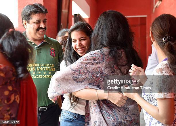 Girl students of St. Thomas School, in joyful mood as they hug each other after passing class XII CBSE Board Exams, results announced today by the...