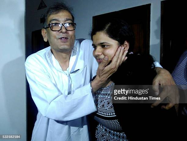 Sukriti Gupta, topper in class XII CBSE Board Exams from Montfort Senior Secondary School, gets hug from her grandfather, on May 21, 2016 in New...