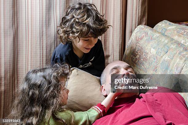 kids drawing a mustache on father's face april fools day - parenting funny stock pictures, royalty-free photos & images