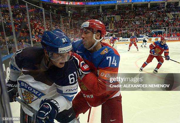 Finland's forward Aleksander Barkov vies with Russia's defender Alexei Yemelin during the semifinal game Finland vs Russia at the 2016 IIHF Ice...