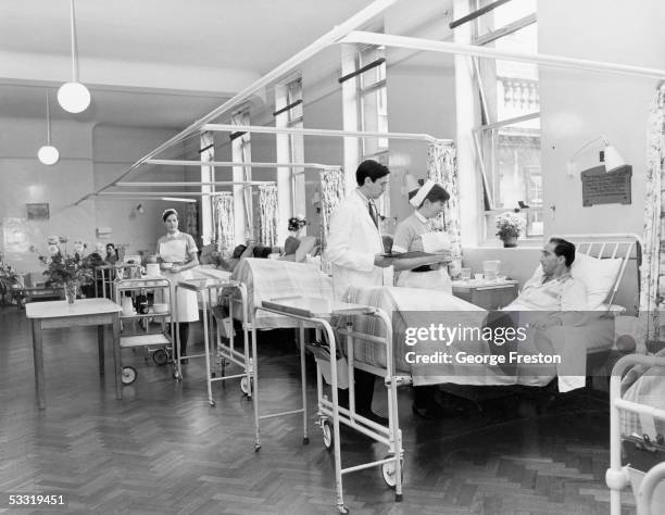 Doctor on his morning rounds in the men's surgical ward at St. Bartholomew's Hospital, London, February 1968.