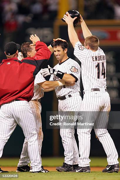 Brad Ausmus of the Houston Astros celebrates with teammates after hitting an RBI double to win the game against the New York Mets in the 9th inning...