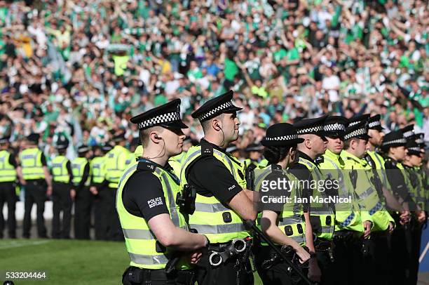 Police look on as Hibs fans celebrate during the Scottish Cup Final between Rangers and Hibernian at Hampden Park on May 21, 2016 in Glasgow,...