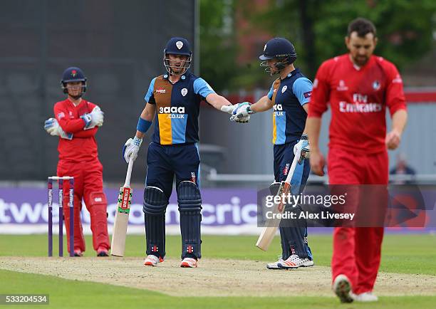 Hamish Rutherford and Neil Broom of Derbyshire touch gloves during their victory in the NatWest T20 Blast between Lancashire and Derbyshire at Old...