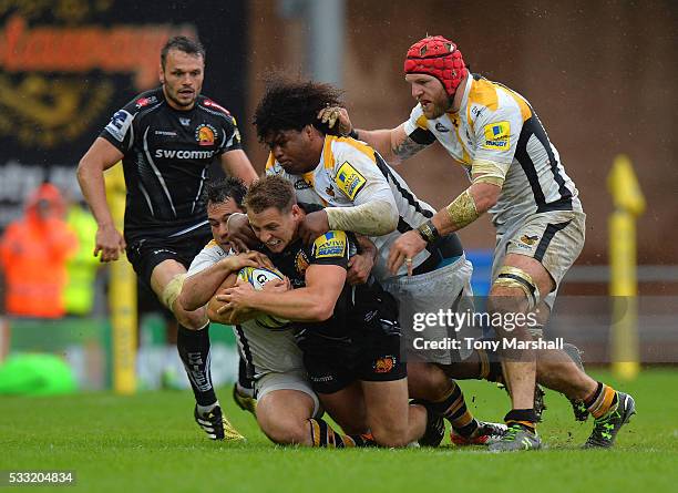 Gareth Steenson of Exeter Chiefs is tackled by George Smith, Ashley Johnson and James Haskell of Wasps during the Aviva Premiership semi final match...