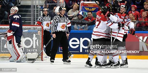 Canada's players celebrate a goal next to US goalie Keith Kinkaid during the semifinal game Canada vs USA at the 2016 IIHF Ice Hockey World...