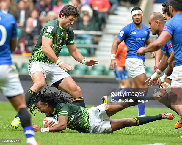 Cecil Afrika of South Africa slips as Ryan Kankowski supports during the match between South Africa and Samoa on day 1 of the HSBC World Rugby Sevens...