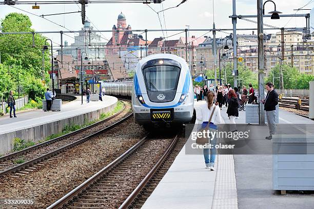 people waiting for incoming train - public transportation stock pictures, royalty-free photos & images
