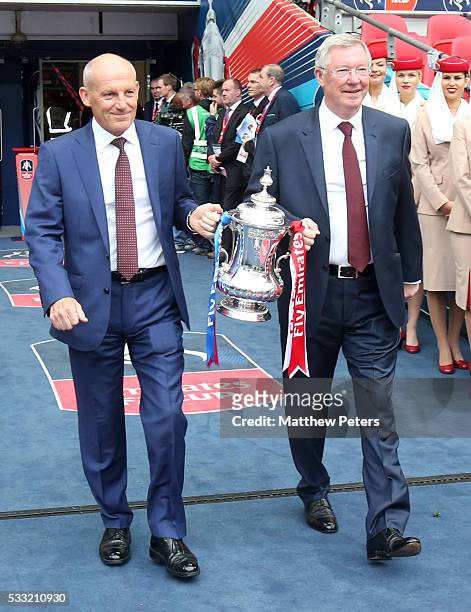 Former managers Sir Alex Ferguson of Manchester United and Steve Coppell of Crystal Palace bring out tha FA Cup ahead of The Emirates FA Cup final...