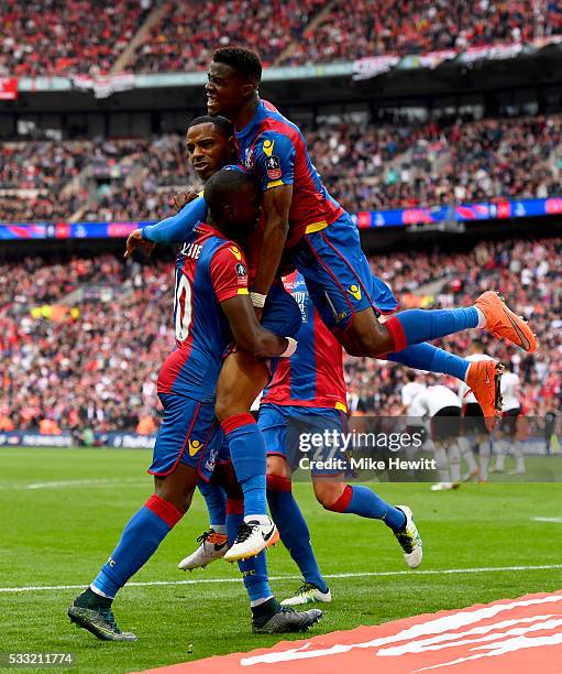 Jason Puncheon of Crystal Palace is mobbed my team mates in celebration as he scores their first goal during The Emirates FA Cup Final match between...