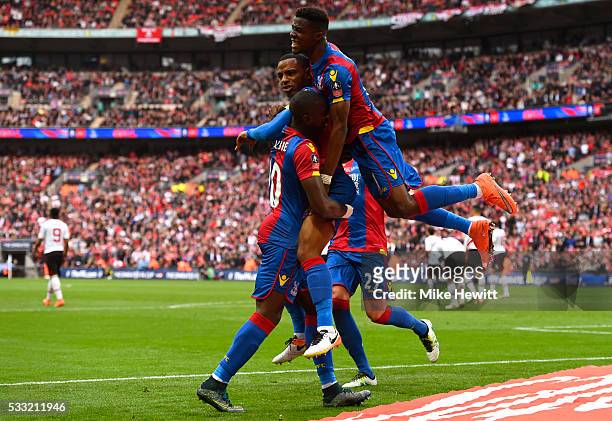 Jason Puncheon of Crystal Palace is mobbed my team mates in celebration as he scores their first goal during The Emirates FA Cup Final match between...