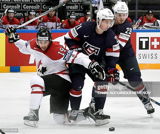 Canada's forward Derick Brassard vies with US forward Dylan Larkin and US defender Jake McCabe during the semifinal game Canada vs USA at the 2016...