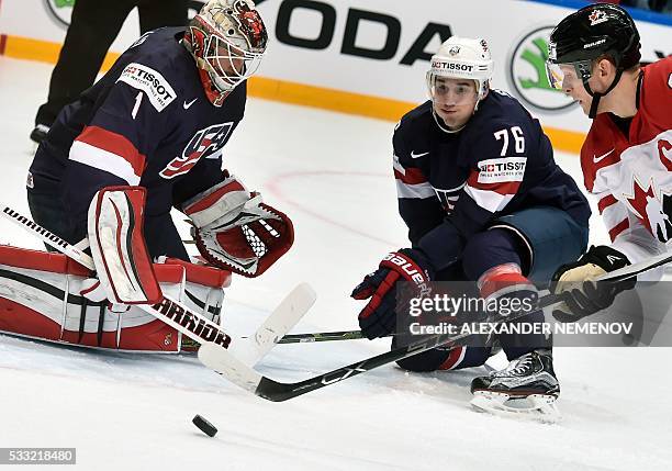 Canada's forward Corey Perry attacks US goalie Keith Kinkaid as US defender Brady Skjei tries to stop him during the semifinal game Canada vs USA at...