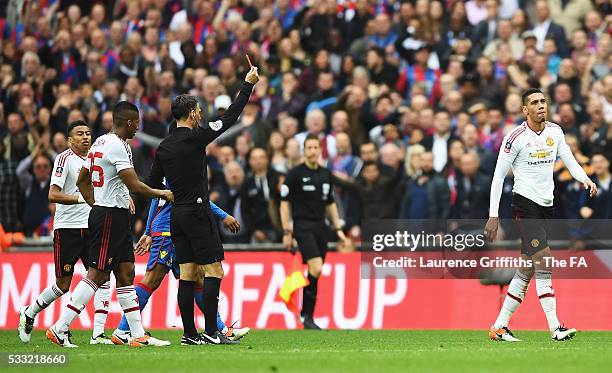 Chris Smalling of Manchester United is shown a red card by Referee Mark Clattenburg during The Emirates FA Cup Final match between Manchester United...