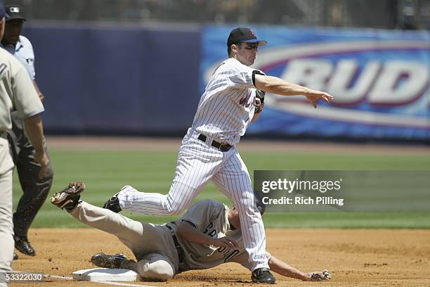 David Wright of the New York Mets fields as Jake Peavy of the San Diego Padres slides, and umpire Chuck Meriwether looks on during the game at Shea...