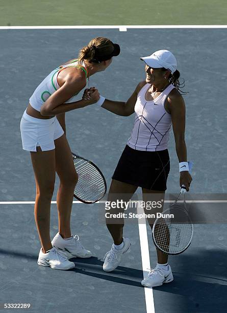 Ai Sugiyama of Japan and Daniela Hantuchova of Slovakia celebrate their win against Nathalie Dechy of France and Francesca Schiavone of Italy during...