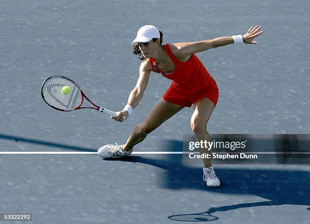 Nathalie Dechy of France hits a forehand against Ai Sugiyama of Japan and Daniela Hantuchova of Slovakia during the Acura Classic at the La Costa...