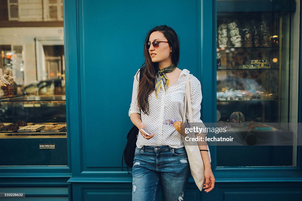 Young Parisian woman buying in a bakery