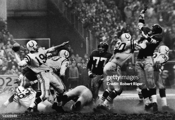American quarterback Johnny Unitas of the Baltimore Colts is about to throw a pass during a play in sudden death overtime of the NFL Championship...