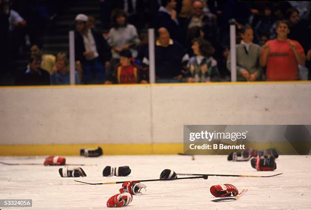 View of the ice, littered with abandoned hockey gloves and sticks, after a fight between opposing teams, October 1987.