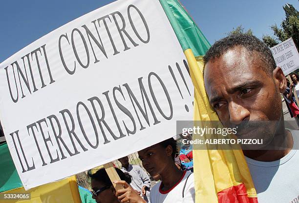 An Ethiopian citizen holds a banner saying "uniti contro il terrorismo" during a rally in central Rome 04 August 2005. The Ethiopian community in...