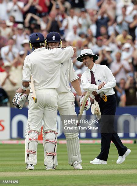 Andrew Flintoff of England is congratulated by Kevin Pietersen of England after reaching his half century during day one of the Second npower Ashes...