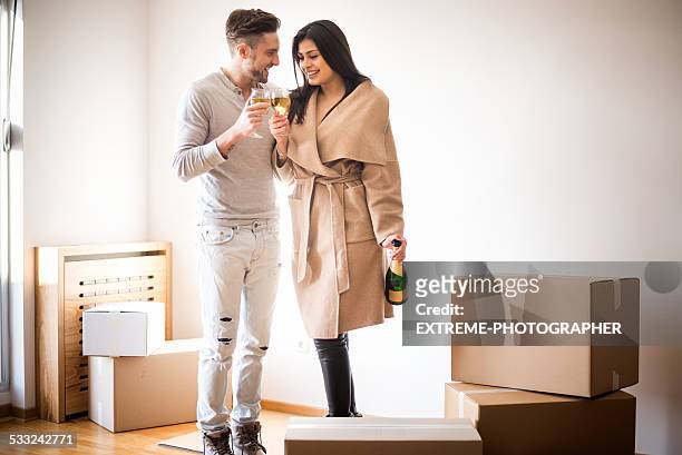 couple celebrating new home - honors 2015 arrivals stock pictures, royalty-free photos & images