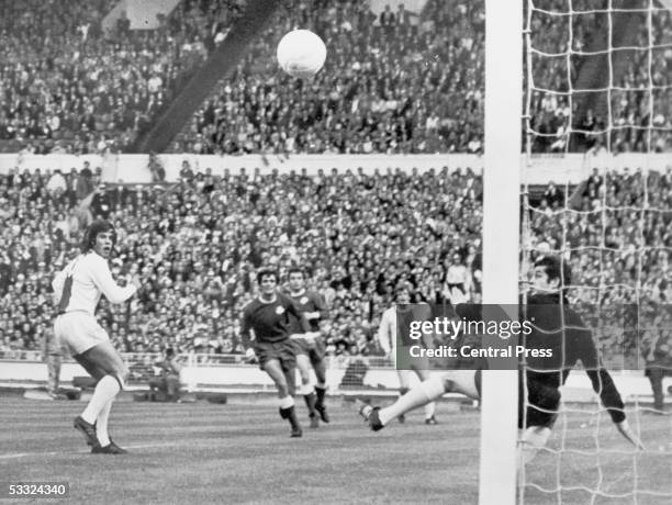 Ajax striker Dick Van Dijk watches his header pass the outstretched hand of Panathinaikos goalkeeper Takis Economopoulos to put his team 1-0 ahead in...