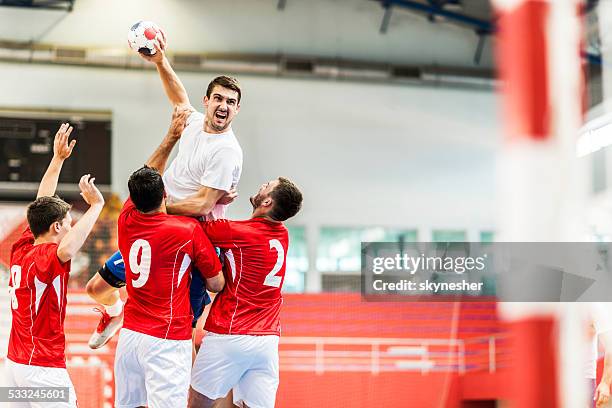 handball player shooting at goal. - handbal stockfoto's en -beelden