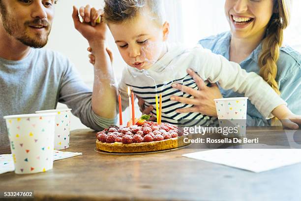home party with family for little boy's birthday - blowing out candles pov stock pictures, royalty-free photos & images