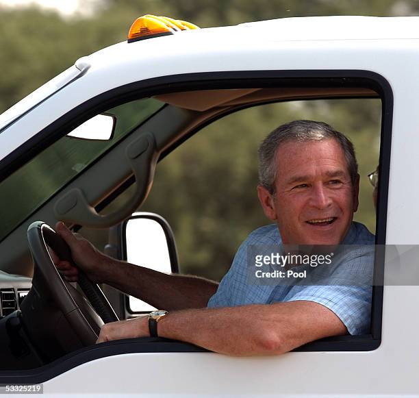 President George W. Bush drives with Columbian President Alvaro Uribe at his ranch August 4, 2005 near Crawford, Texas. Bush said during his remarks...